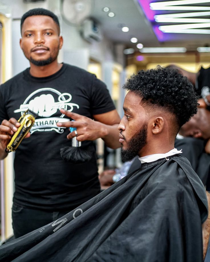 Barber giving a precise fade haircut to a Black man